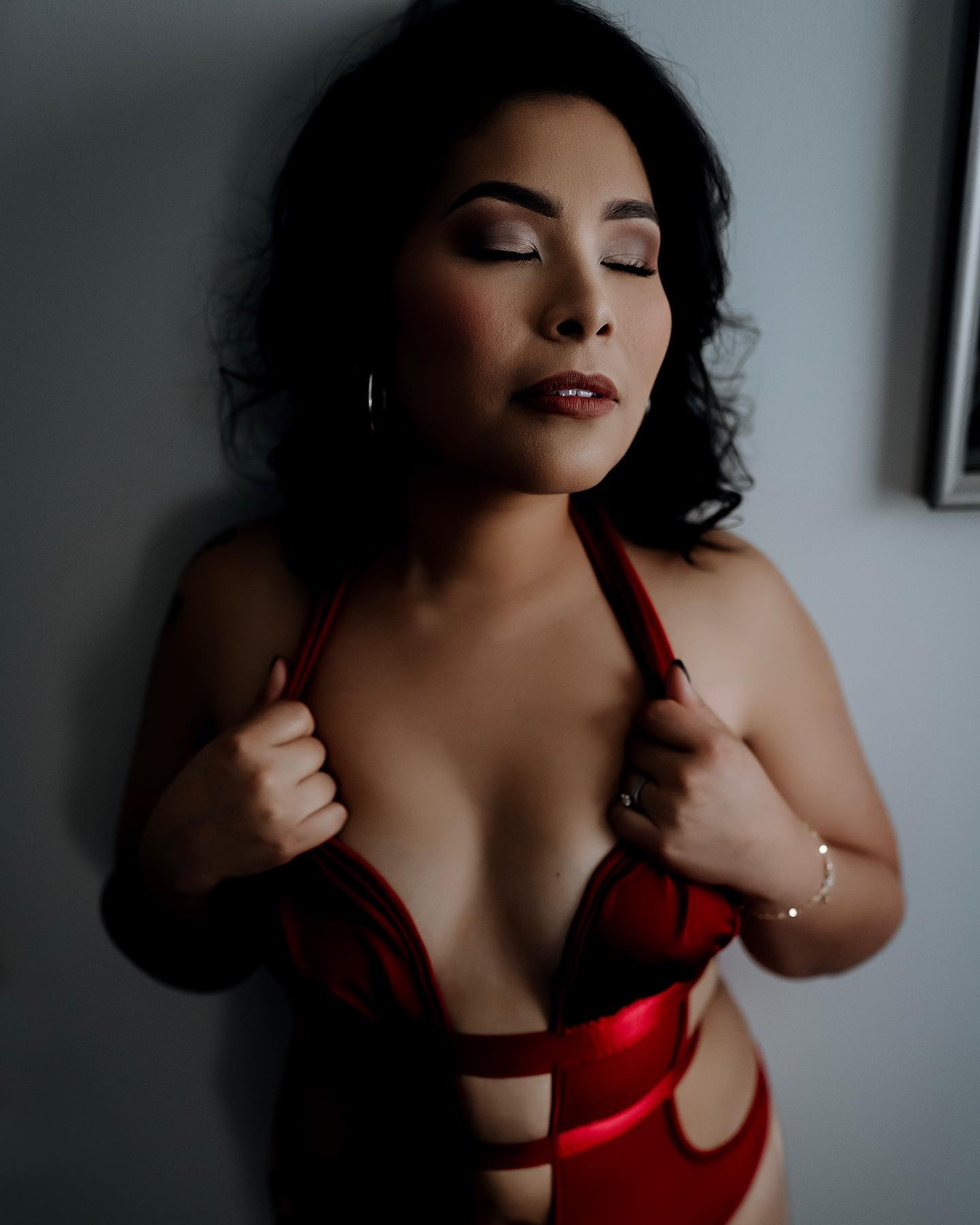 red bodysuit boudoir photoshoot raleigh chapel hill kinston wilmington hampstead jacksonville new bern atlantic beach morehead city swansboro topsail island north carolina photographer moody and emotional boudoir
